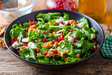 Arugula salad with cheese served with walnuts and pomegranate. Turkish name; Roka salatasi