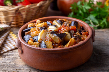 Top view of Turkish dish Guvech - baked meat with eggplant and traditionally served in earthenware...
