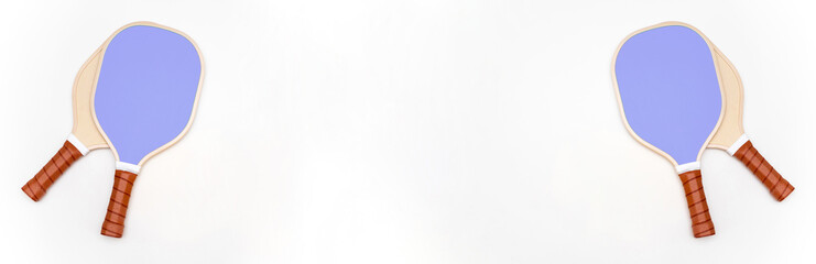 Composition of 4 pickleball rackets on a white studio background with copy space in the center.Pickleball concept. Pickleball advertising.