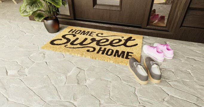 4K Slow Hand-held Pan and Zoom of a Home Sweet Home Doormat at the Front Door with Shoes.