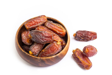 Dried date palm fruits in wooden bowl on white background