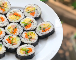 fresh healty gimbap on a white plate for lunch
