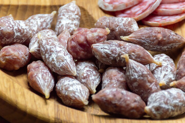 Appetizer for beer, small sausages on a wooden tray