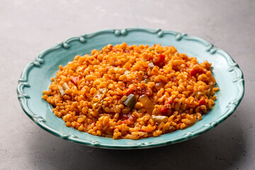 Traditional turkish bulgur pilaf with tomato sause in plate (Turkish name; meyhane pilavi)