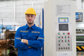 Male electrician engineer maintenance electric system in industry factory. Factory male worker at work in the industry factory, work with CNC machine. Factory engineer male worker maintaining machine