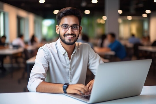 Young man or corporate employee using laptop at office