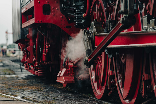Outer workings of a classic steam train seen up close.