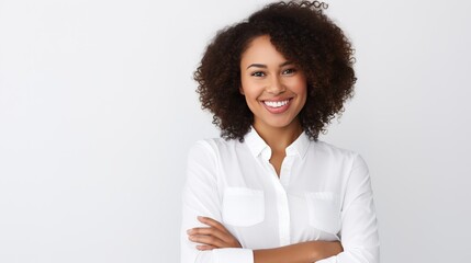 portrait of a smiling woman standing and crossing her arms against a white backdrop