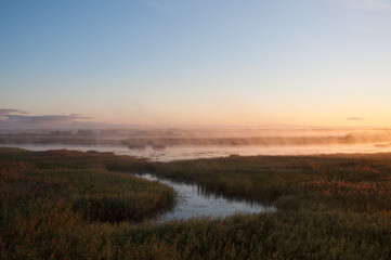 Sunrise and early morning fog in the Kokemäenjoki river delta in Pori, Finland