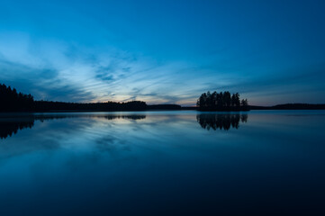 Autumn night scenery in the forests by a lake in Finland