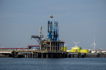 Industrial gas installation. Transshipment and Storage for LNG or liquefied natural gas in the port of Rotterdam. Ships moor for the transport of LNG. Energy price crisis.