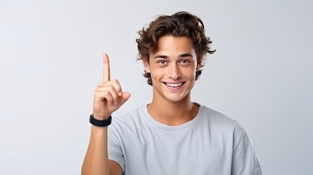 Young man gives a thumbs up and winks. While isolated, a male's face, smile, and hand gesture express yes, agreement, and vote emoji.