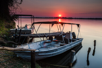 Boats at sunset on the Zambezi river, Lower Zambezi National Park, Zambia, Africa.