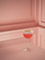 Pink cocktail with foam and lemon.