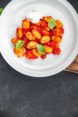 gnocchi tomato sauce no meat potato dish meal food snack on the table copy space food background rustic top view vegetarian vegan food  