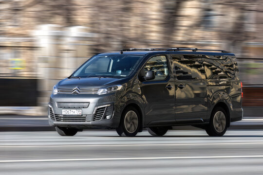 Citroen SpaceTourer in motion on the city road on high speed. Gray light commercial vehicle is driving on the highway, front side view