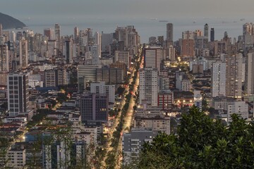 City of Santos, Brazil at sunset. Ana Costa avenue illuminated and in the background, the sea and...