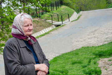 old woman with a scarf and white hair typical granny in eastern europe rural areas