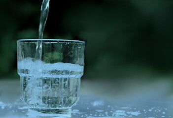 Glass of clear drinking water on a table top no people stock photo