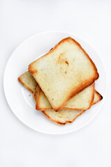 Fried toast on a white plate. Baked bread for sandwiches. Vegan food.