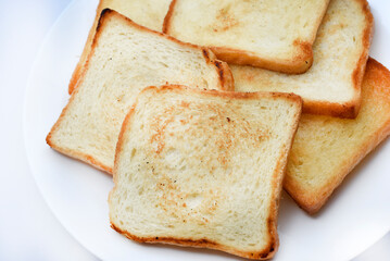Fried toast on a white plate. Baked bread for sandwiches. Vegan food.