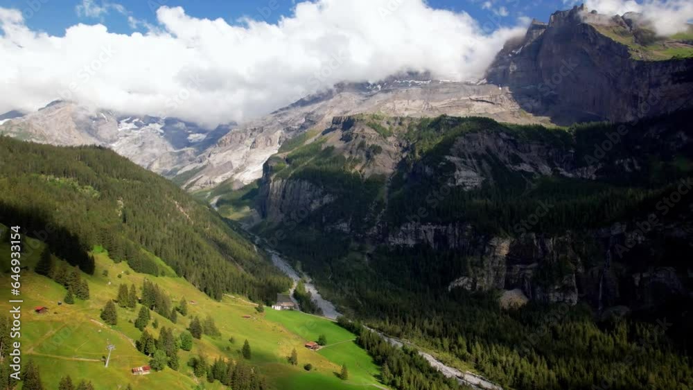 Wall mural Swiss nature scenery. Kandersteg village with stunning valley surrouded by high Alps mountains. popular tourist ski resort. Canton Bern, Switzerland. aerial view