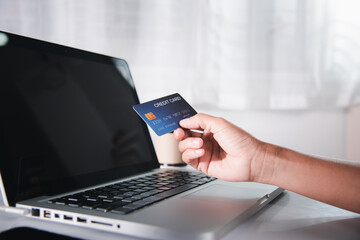Female register via credit cards on computer make electronic payment security online, Woman hands holding credit card and using laptop with product purchase at home, Internet online shopping concept