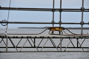 Power distribution panel on scaffolding for bridge maintenance.