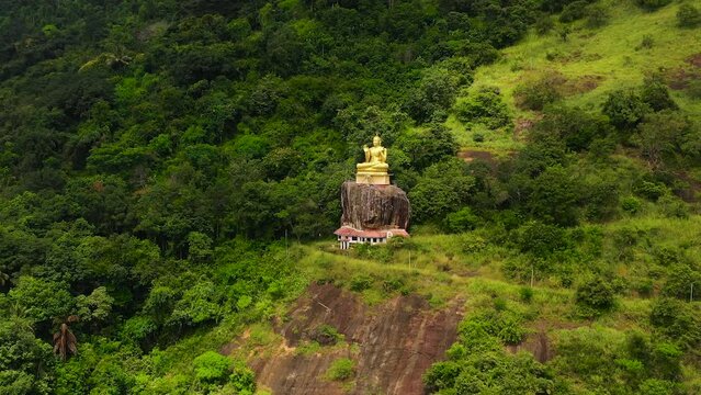 Aerial view of Buddha statue, Seated Buddha on rock, Aluvihara Rock Temple, Matale, Central Province, Sri Lanka, Asia.