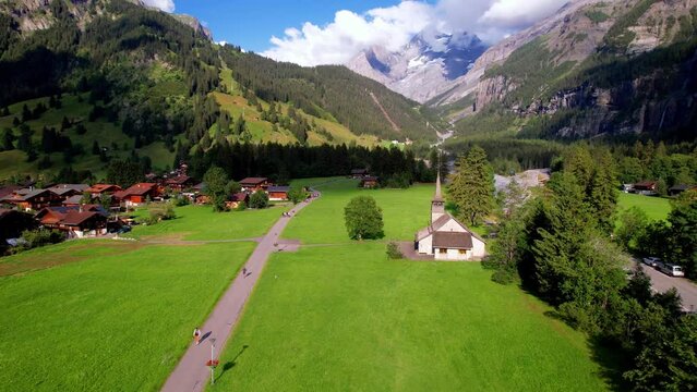 Swiss nature scenery. Kandersteg village with stunning valley surrouded by high Alps mountains. popular tourist ski resort. Canton Bern, Switzerland. aerial view