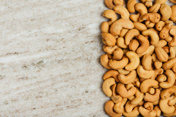 Salted roasted cashew nuts close-up.