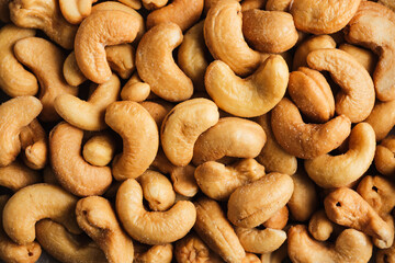 Salted roasted cashew nuts close-up.