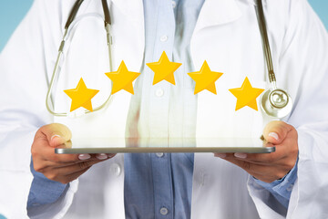 Medical services rating. Unrecognizable young female doctor holding digital tablet with five stars...
