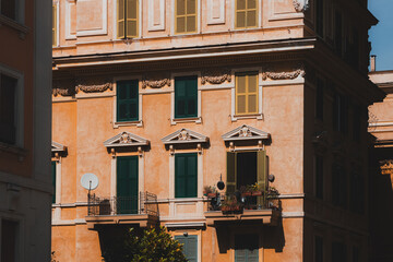 Dramatic light and shadow over colourful residential buildings and architecture in the charming neighbourhood of Trastevere the old town of historic Rome, Italy.