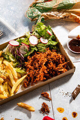 pulled pork with french fries and some souce in a fast food restaurant still life - 646951726