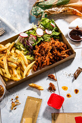 pulled pork with french fries and some souce in a fast food restaurant still life - 646951776