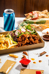 pulled pork with french fries and some souce in a fast food restaurant still life - 646951782