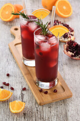 Pomegranate orange holiday punch with ice and rosemary. This is a sweet, tart and refreshing...