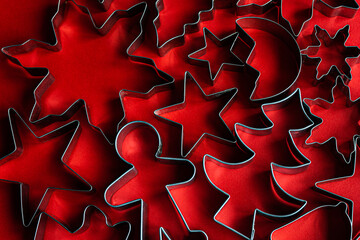 Christmas cookie cutters on red background