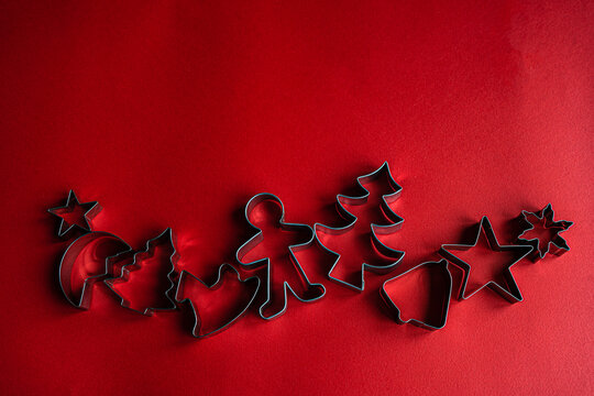 Christmas cookie cutters on red background