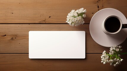 two blank business cards elegantly placed alongside fresh flowers on a wooden table. The flat lay, minimalist style, and light color palette emphasize the essence of professionalism and simplicity
