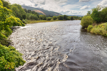 River Spey, near Fochabers, Scotland., gleaming in the afternoon sun. The river is important for salmon fishing and whisky production.