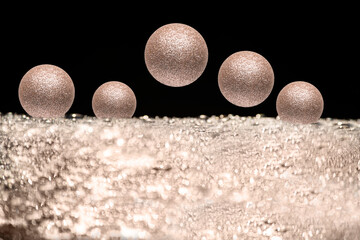 Christmas New Year background. Golden sparkling New Year's toys Christmas balls on a silver and black background