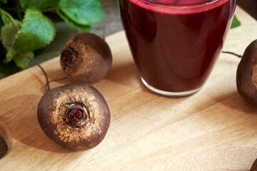 Fresh beets with copy space, with beetroot juice in the background