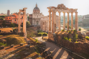 Golden sunrise light over the ancient classical ruins of the historic Roman Forum as seen from Capitoline Hill or Campidoglio in Rome, Italy.