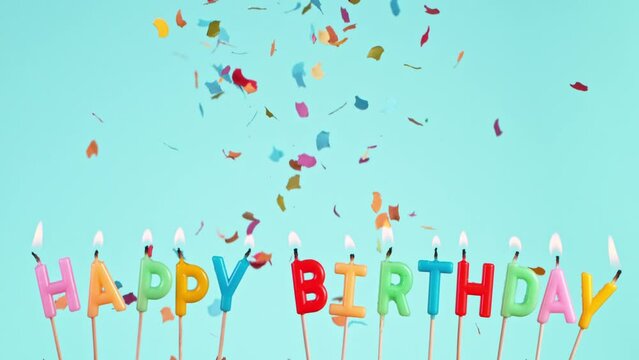 Birthday Confetti Falling on Pastel Blue Background. Super Slow Motion, 1000 FPS.