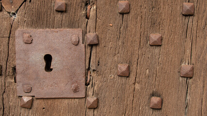 Old wooden door with metal bolt