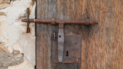 Old wooden door with metal bolt