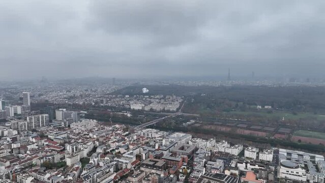 The city's modern skyline in La D&eacute;fense seen from a cloudy altitude.
