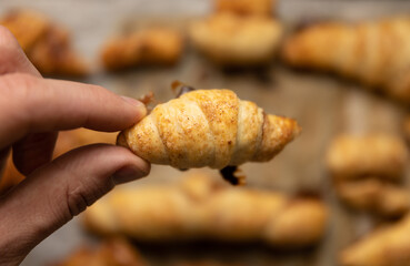 home made pastry in hand and on a baking tray